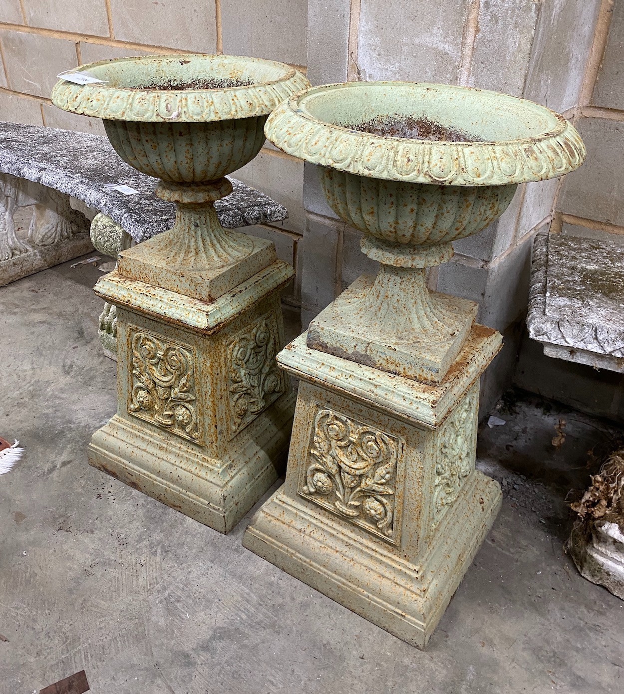 A pair of Victorian cast iron garden urns and pedestals, diameter 43cm height 80cm